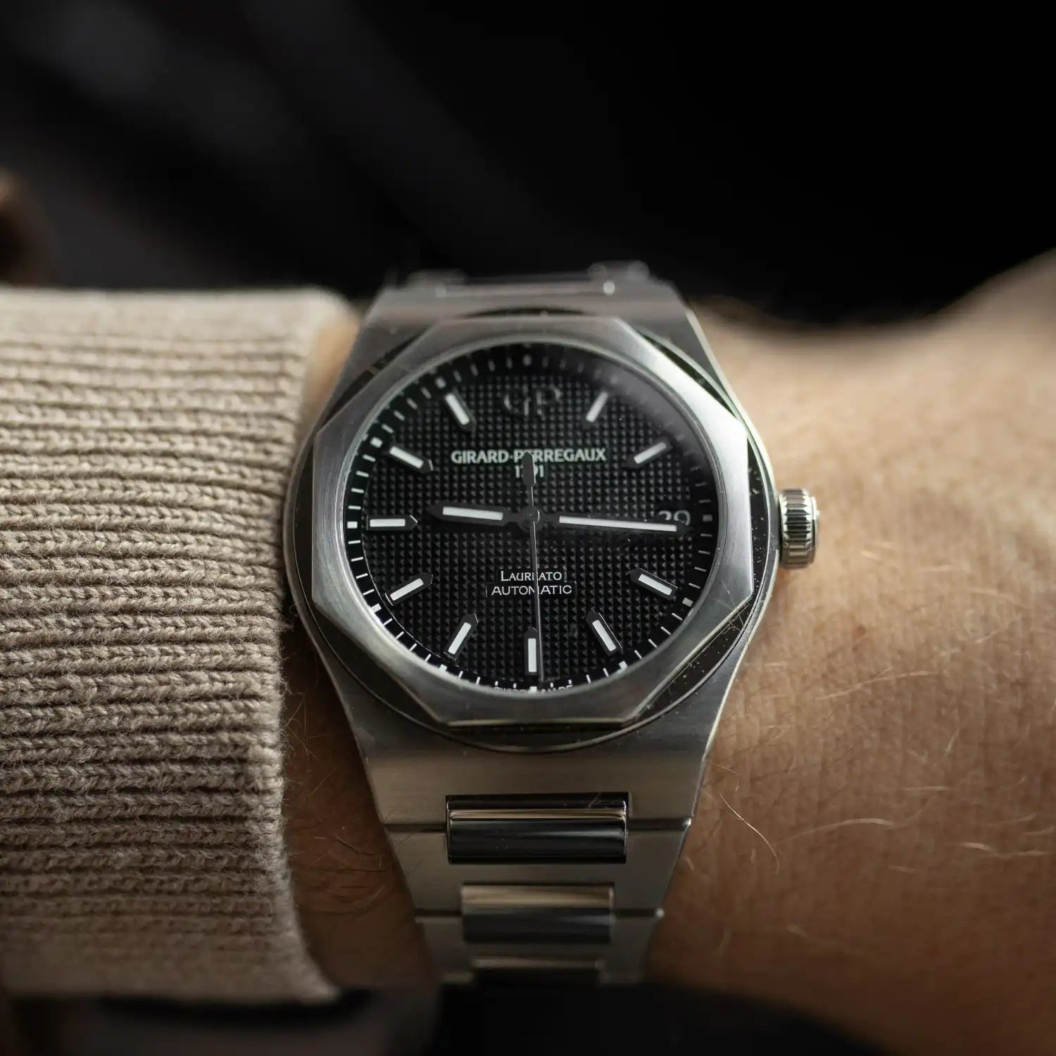 Luxury Girard-Perregaux wristwatch with stainless steel bracelet worn on the wrist