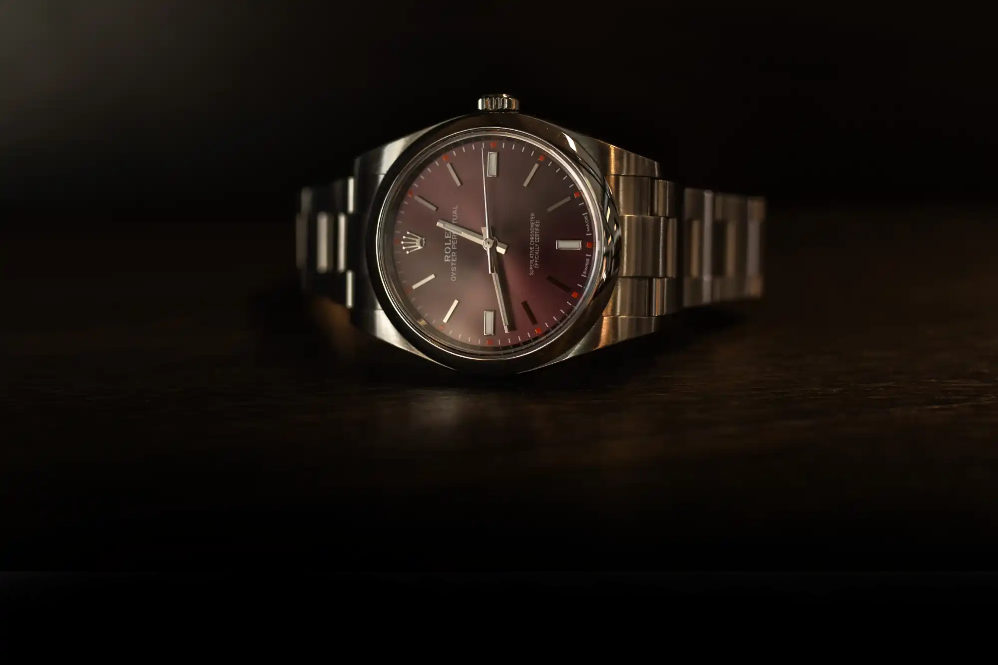 Rolex Oyster Perpetual watch with burgundy dial and stainless steel bracelet